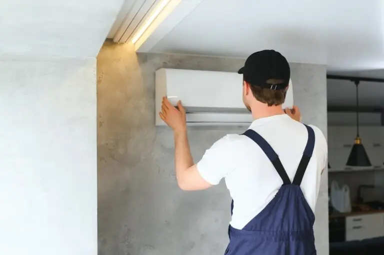 happy male technician repairing air conditioner utc x jpg